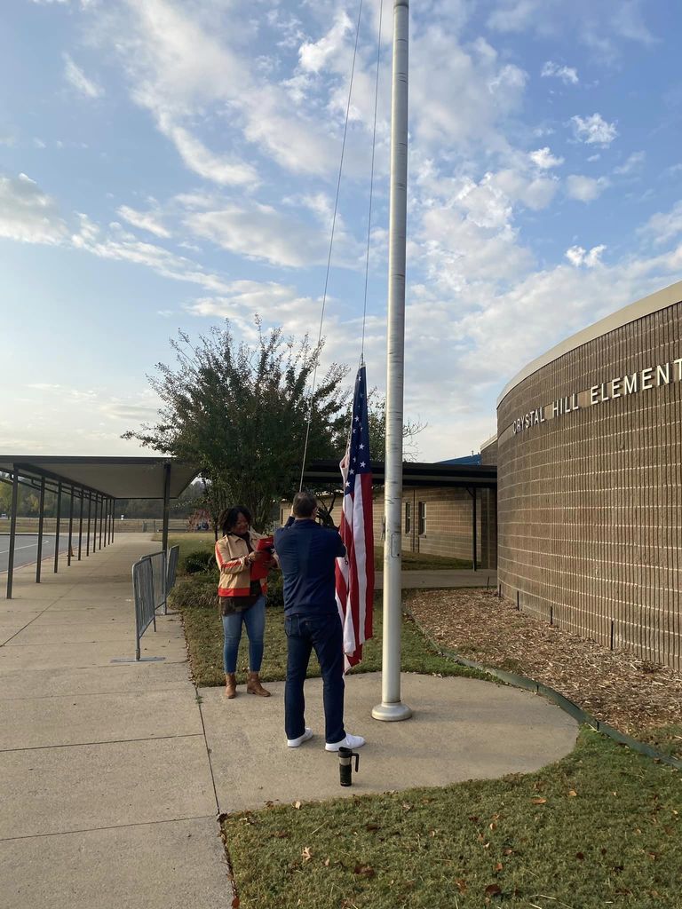Ms. Smith and Mr. Dewitt hoisted the flags on Veterans Day 2022. 