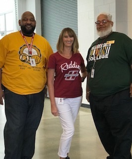 Mr. Burgess is wearing UAPB, Ms. DeVun is wearing HSU and Mr. Patterson is wearing Philander Smith t-shirts